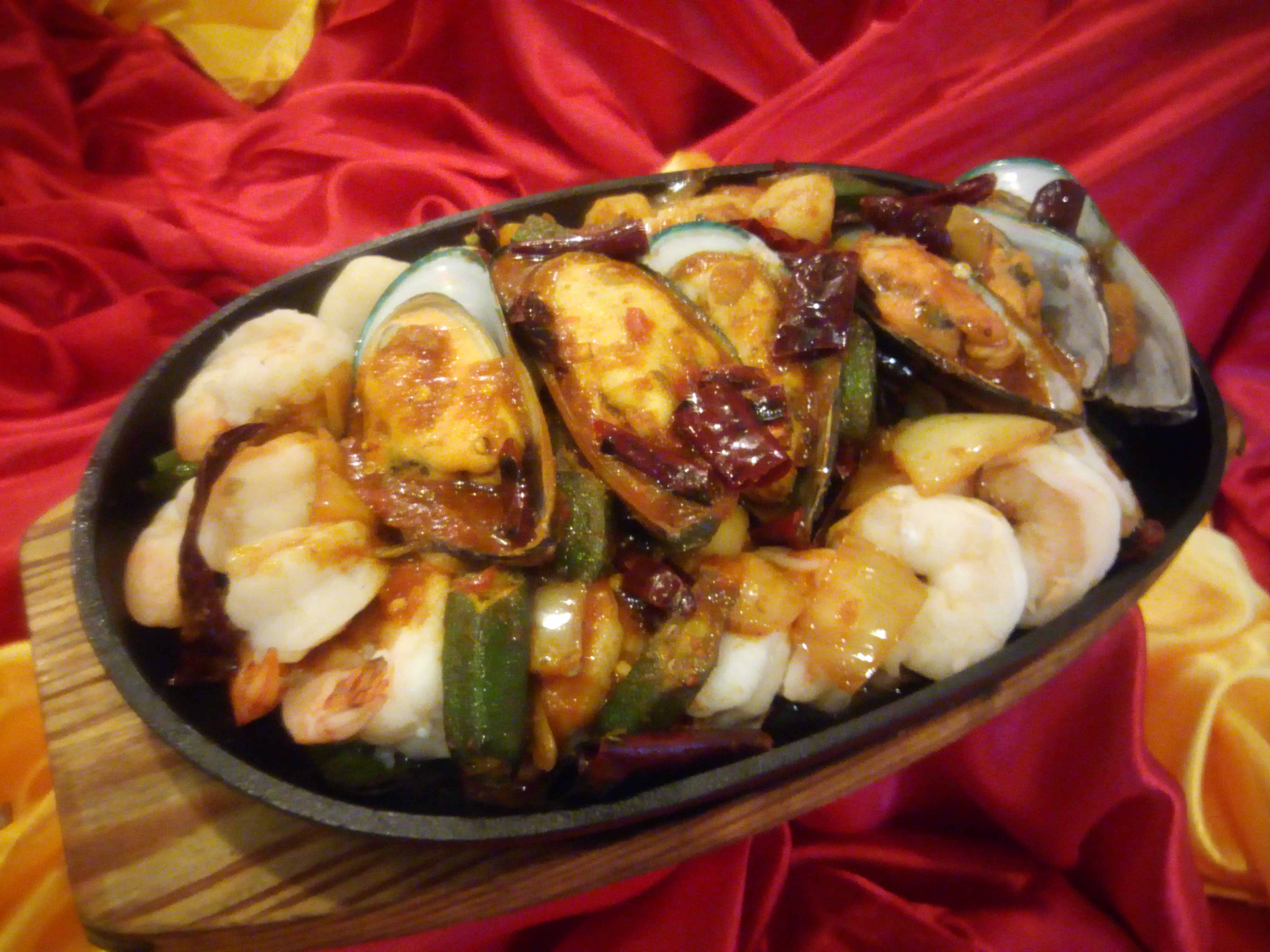 Pan Fried Trio Seafood with Spicy Sauce on Hot Plate