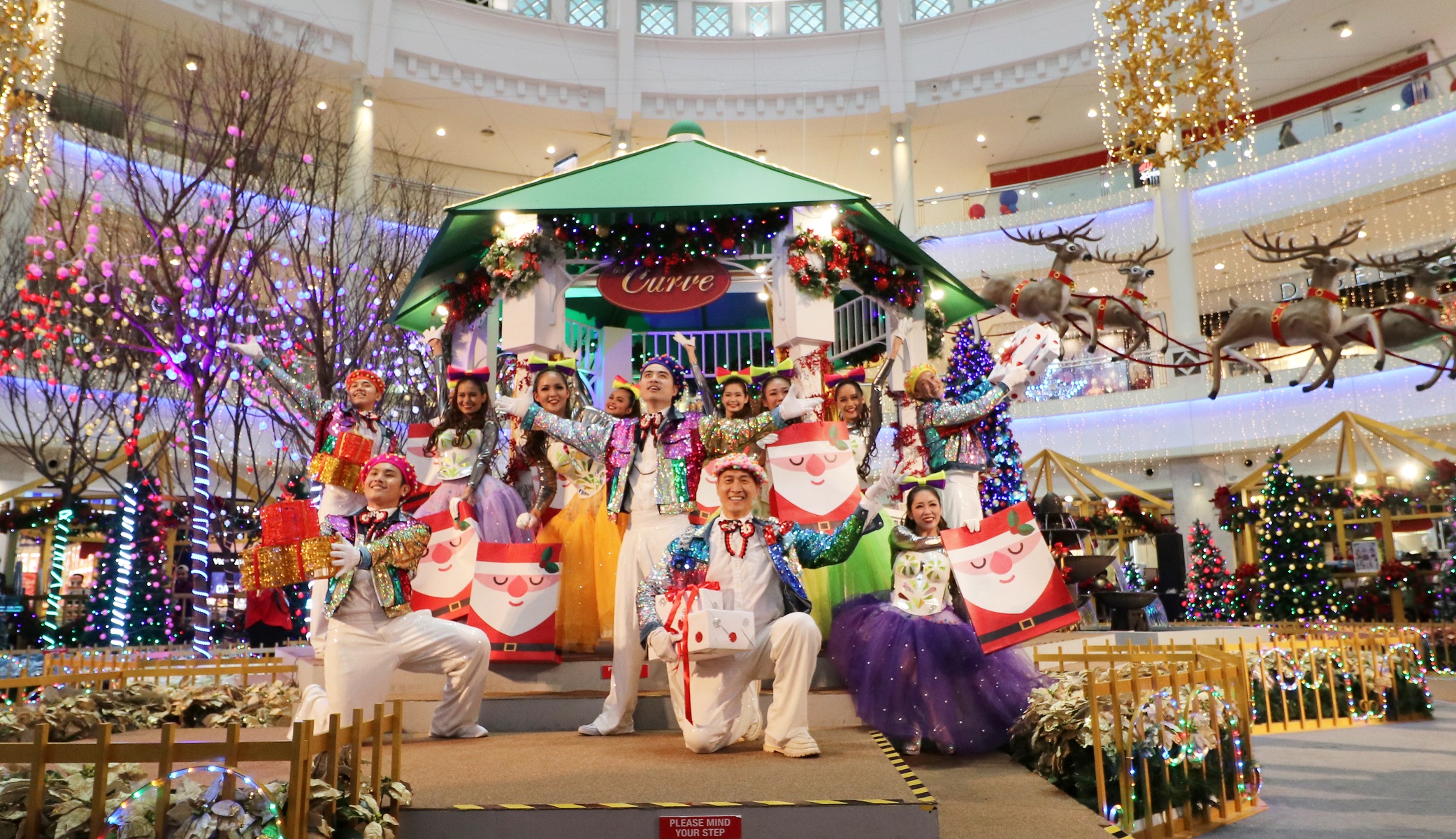 Cheery performers of the All I Want for Christmas musical dazzling the stage with jolly Christmas melodies.